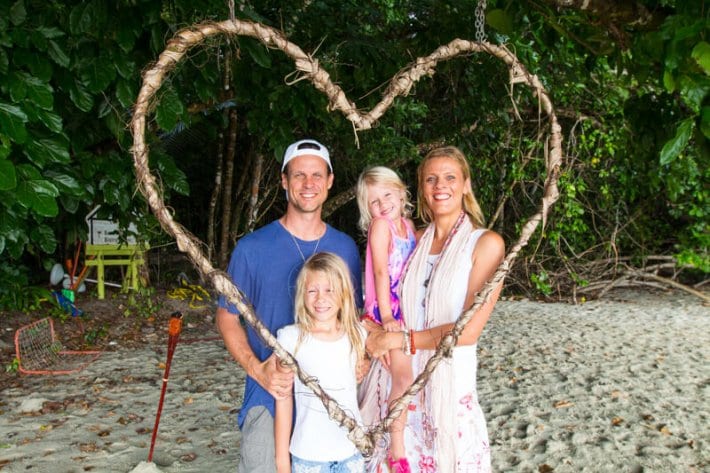 a family standing next to a heart sign