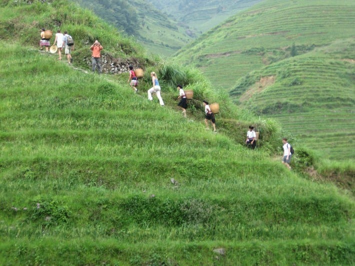 people hiking up a mountain