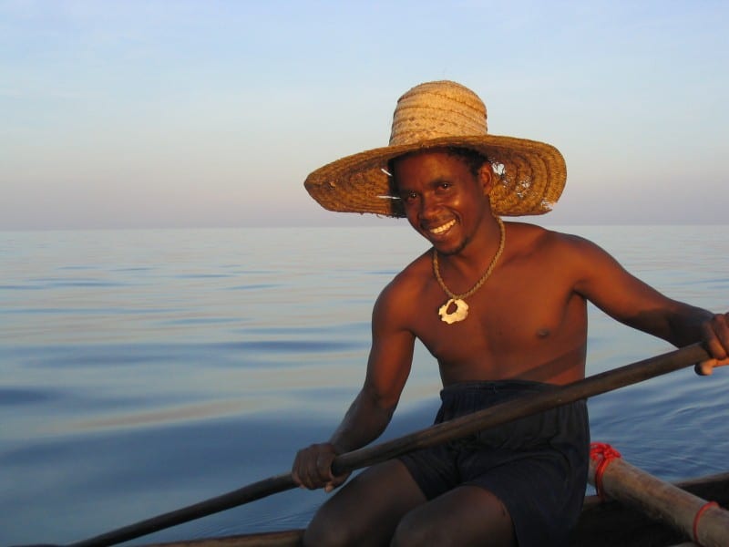 a man sitting on a canoe