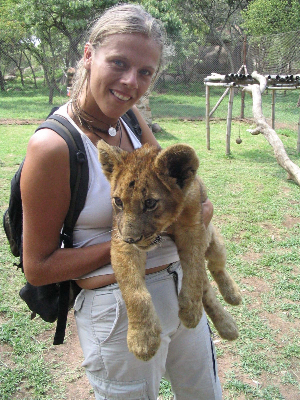 woman holding lion cub