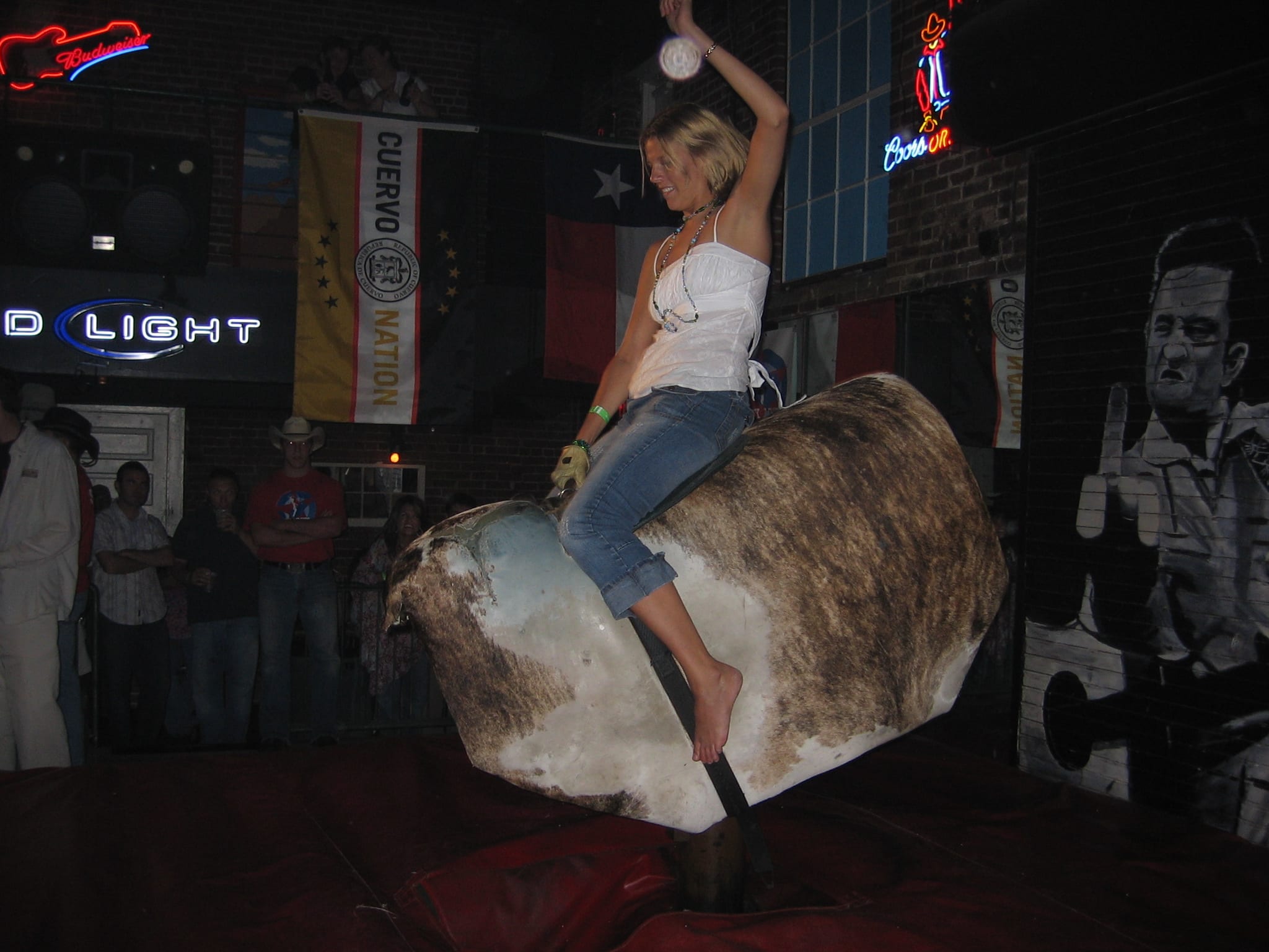 a woman riding a mechanical bull
