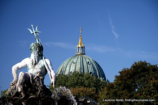 a statue in front of a dome building