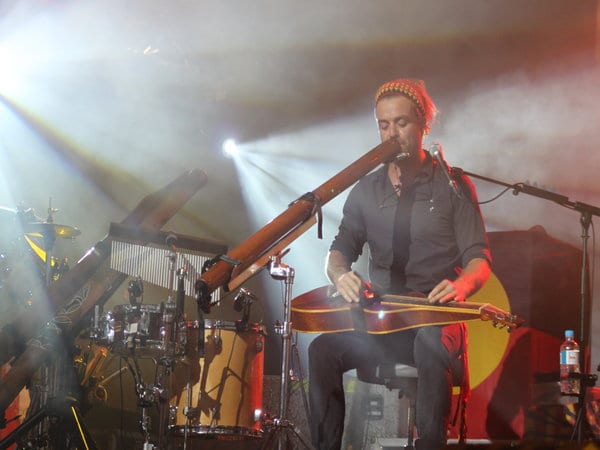 a man playing instruments on stage