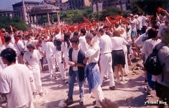 crowds wearing red and white covered in flour for san fermin pamplona