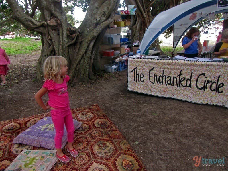 girl standing in front of a tent