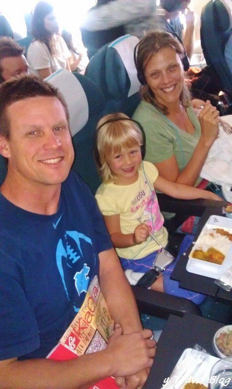 family on plane with baby on lap