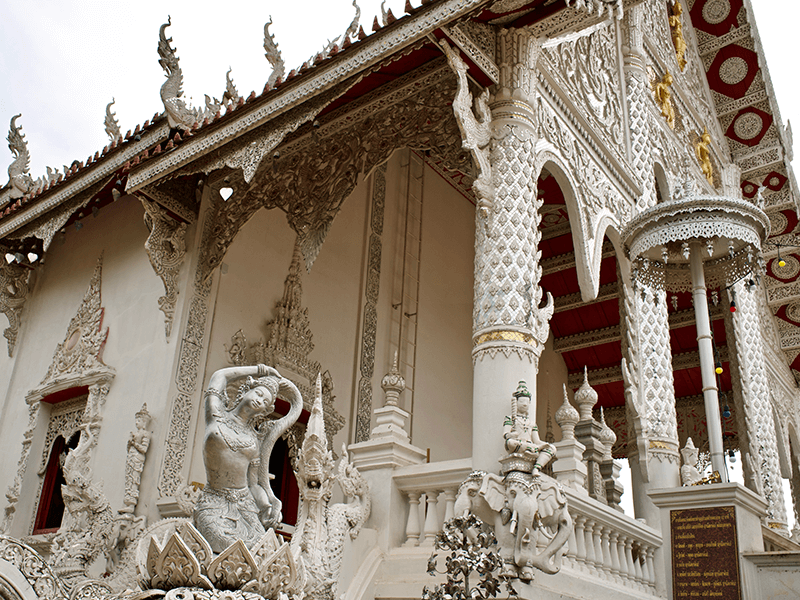 a white temple with white statues