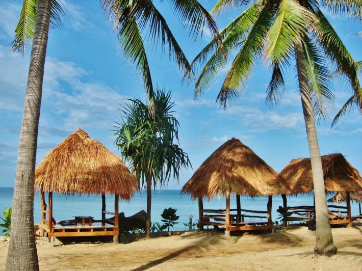 beach huts and palm trees on koh lanta beach
