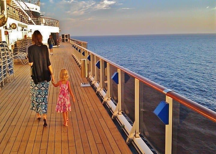 mom and daughter walking on cruise deck
