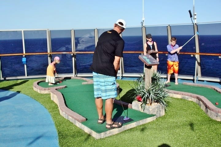 a man playing mini golf