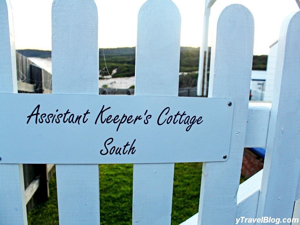 a sign on a picket fence