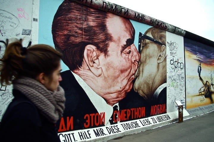 a mural of two men kissing