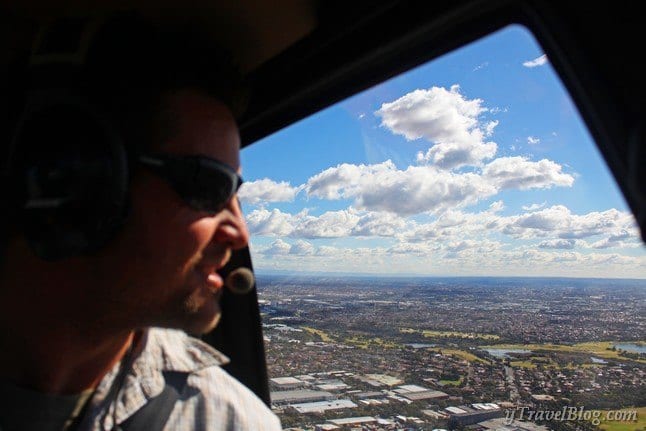 man looking out of a helicopter window