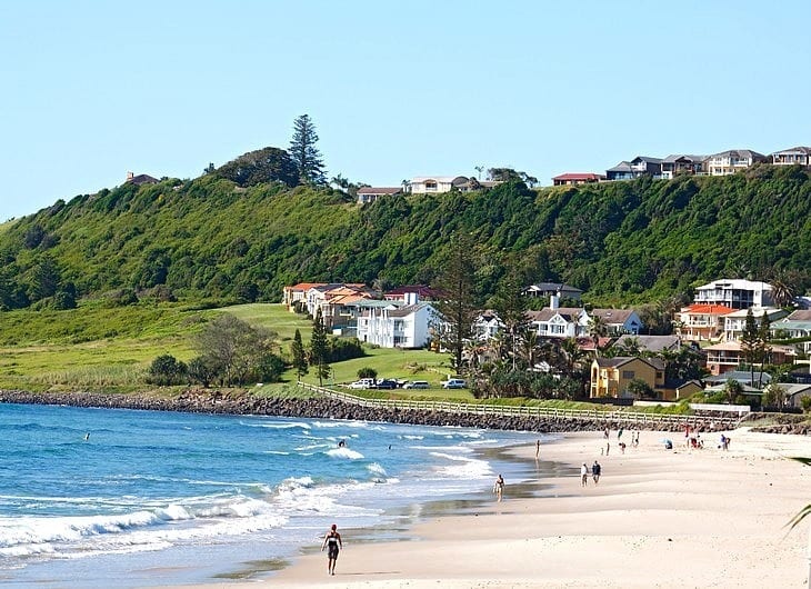 Lennox beach with hill and lighthouse in distance