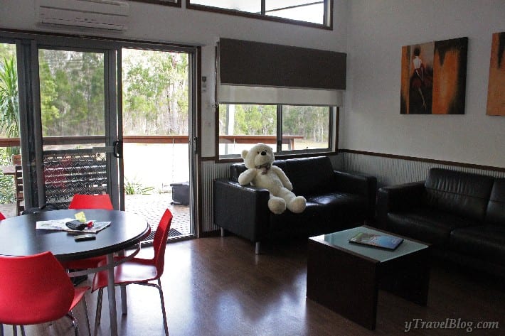 a large teddy bear sitting on a couch in a living room
