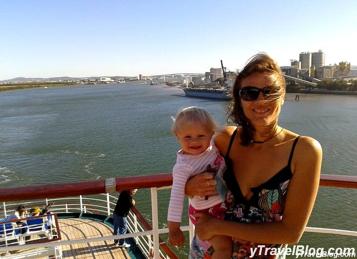 a woman holding a baby on a boat deck