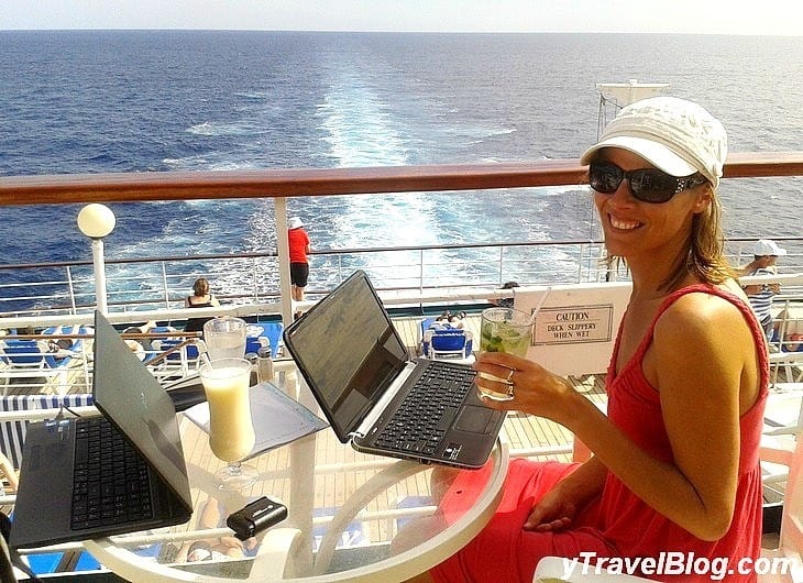 a woman working on a computer on a cruise balcony