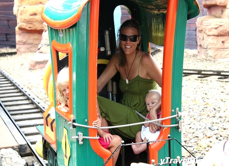 a woman and children sitting on a train cart