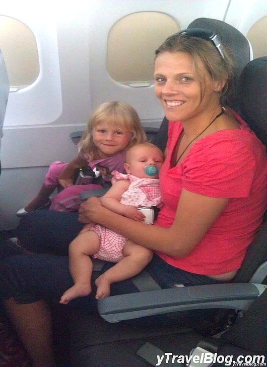 a woman and children sitting on plane seats