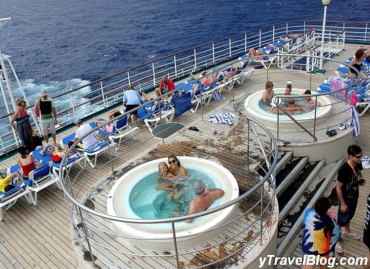 people in hot tubs on a cruise ship