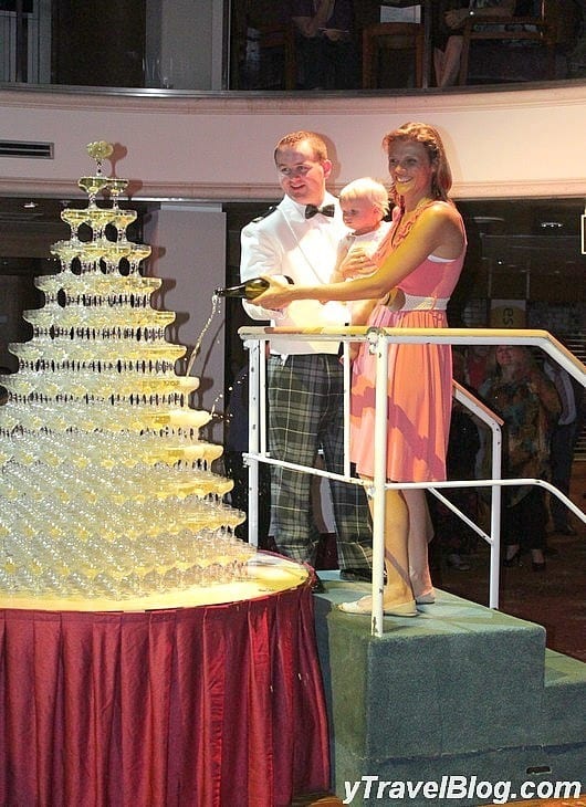 a woman pouring champagne on a glass tower