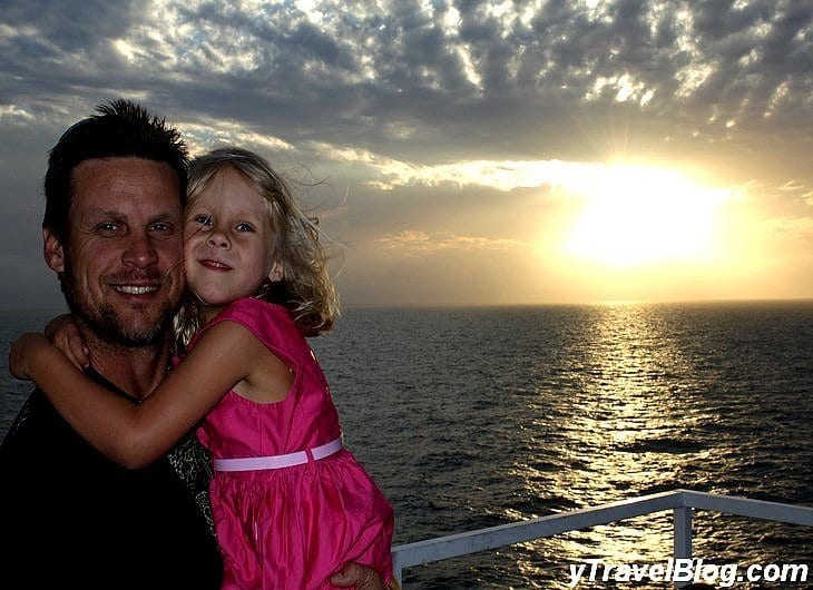 a man holding a girl on a cruise balcony