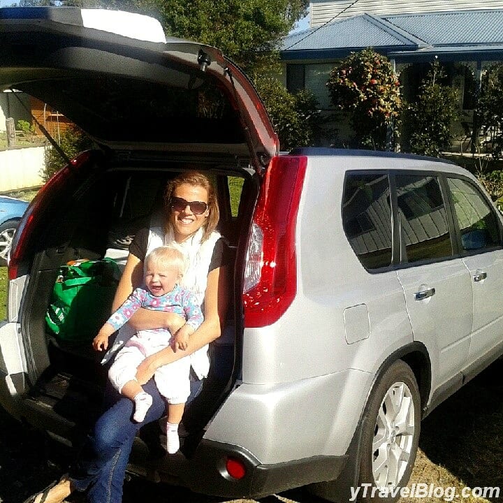 a women and a baby sitting in the back of a car