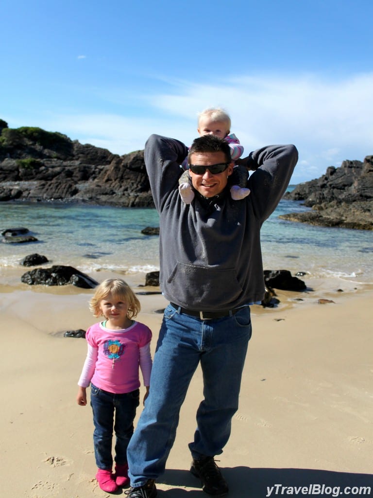 a man and children standing on a beach