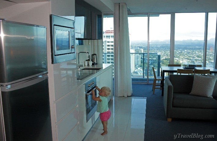 a little girl standing in a kitchen