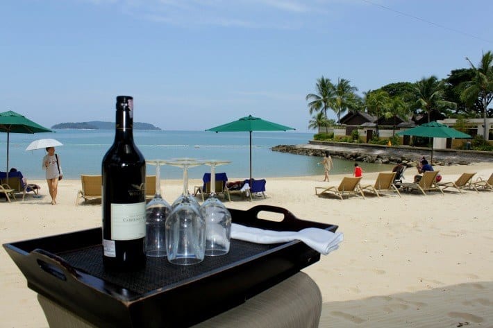 table on beach with wine and food