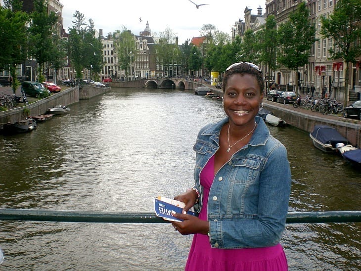 woman posing in front of amsterdam canal