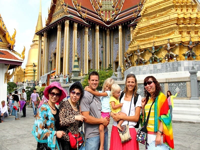 family and friends posing for camera at the grand palace