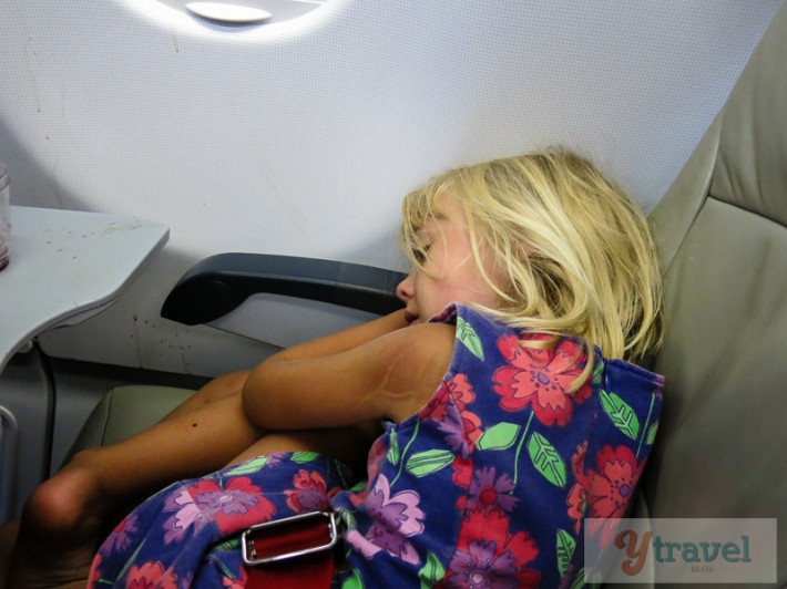 girl sleeping on plane seat
