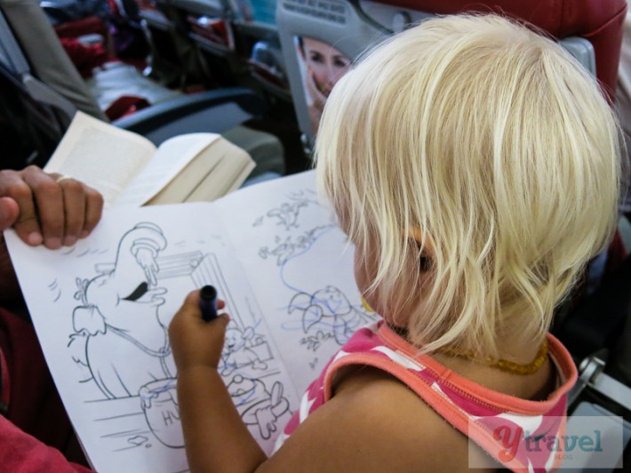 toddler coloring on plane
