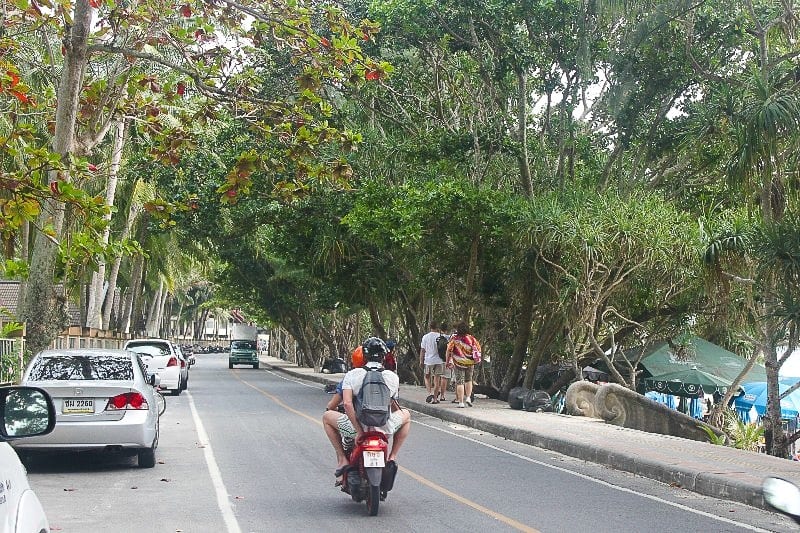 people riding a motorbike on the road
