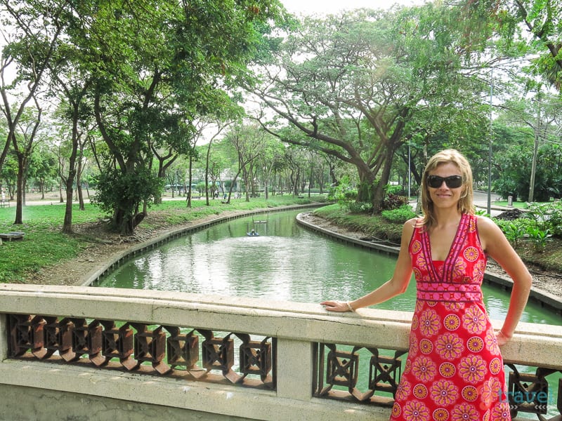 woman posing with view of small river in park