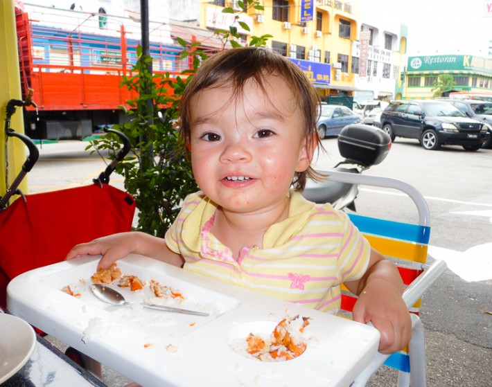 child eating First Curry in Little India Penang
