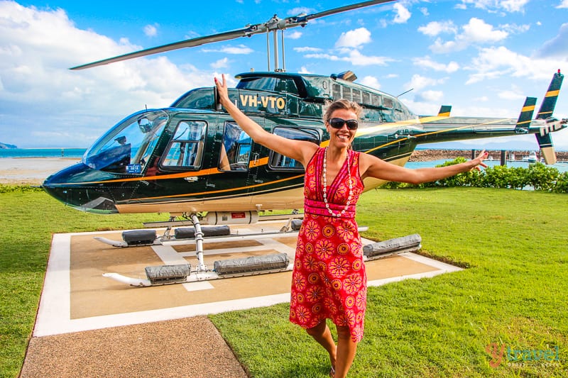 woman standing in front of a helicopter