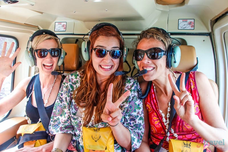 girls giving peace signs while on a Helicopter Flight over the Whitsunday Islands, 