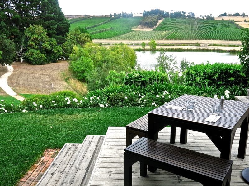 table and chair on deck overlooking vineyards at Joseph Chromy Vineyard, 