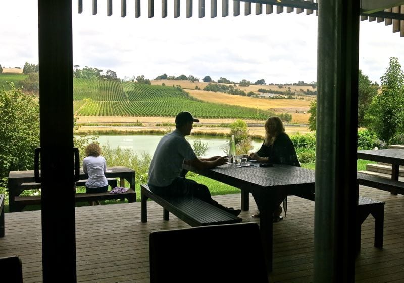 people sitting at table overlooking Joseph Chromy Vineyards, Tasmania