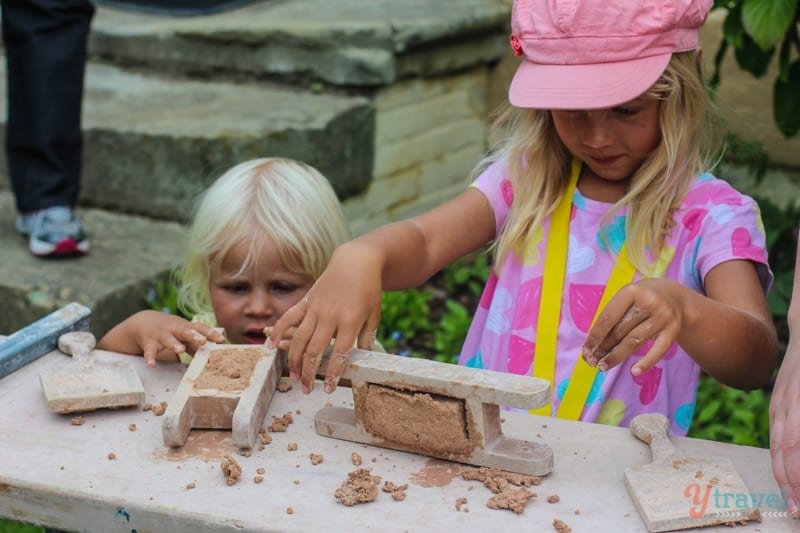 girls making objects with clay on a table