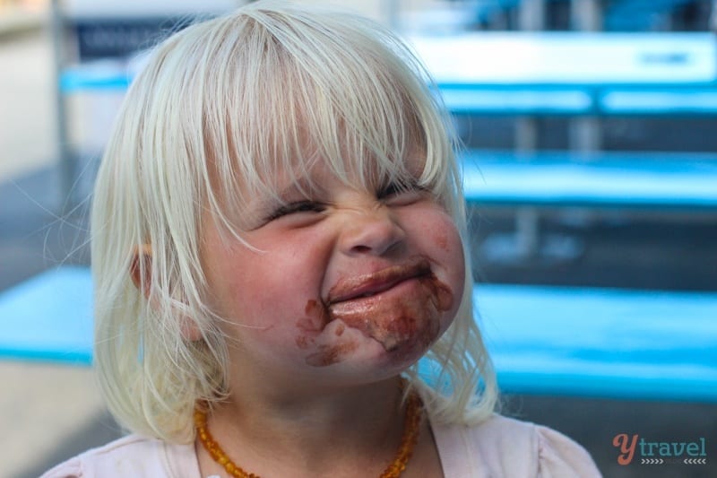 a little girls face covered in ice cream