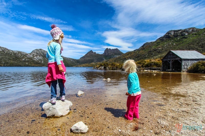 girls standing on rocks in a lake