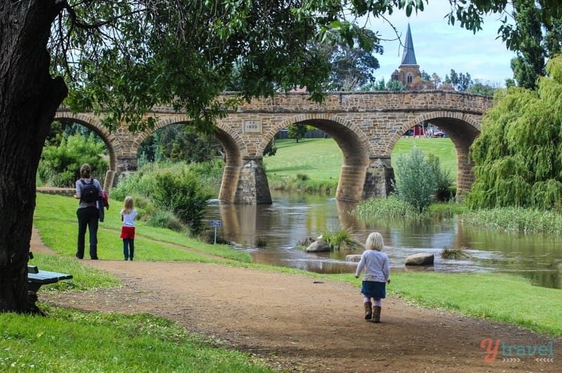 girls looking at stone bridge over river Richmond, Tasmania, Australia