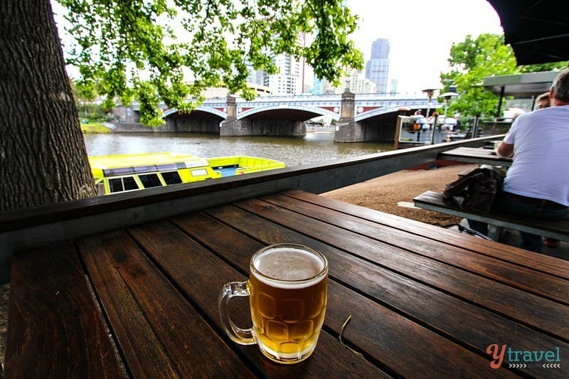 schooner of beer on table with views of the Yarra river at Riverland Pub, Melbourne, 