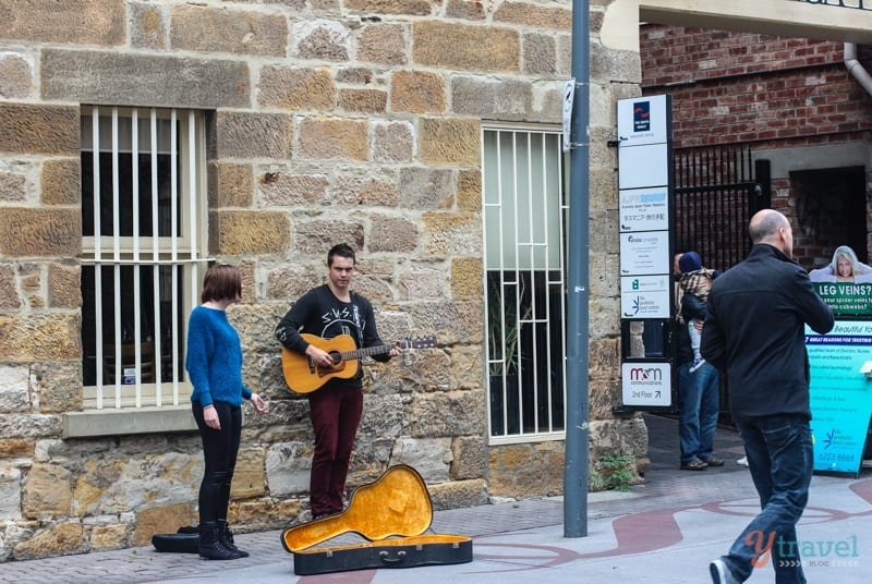 man playing guitar on the street