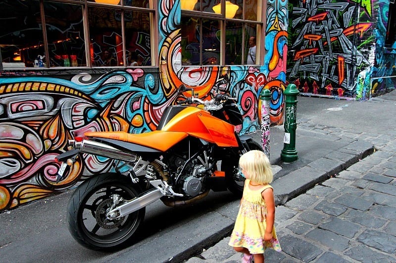A colorful motorcycle is parked on the side of a road