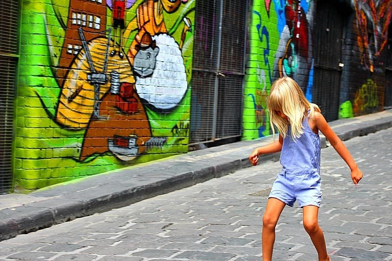 A little girl walking down the street