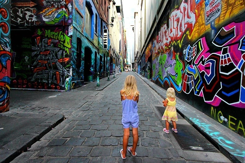 girls standing in Hosier Lane looking at grafitti